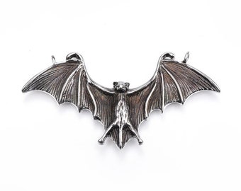 May include: A silver bat pendant with detailed wings and a textured finish.