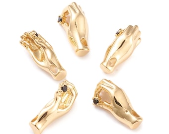 May include: Five gold-toned hand charms with black gemstone accents. Each charm features a hand in a different gesture.