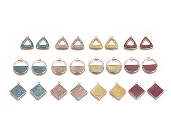 May include: Assortment of 18 gold-toned metal charms with a variety of shapes and colors. The charms are in the shapes of triangles, circles, and squares. The colors are blue, pink, and yellow.