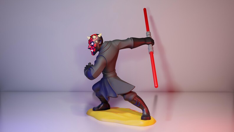 May include: A figurine of Darth Maul from Star Wars. The figure is in a dynamic pose, holding a red lightsaber. The character has a red and black face with horns, wearing a dark gray outfit and black boots. The figure stands on a yellow base.