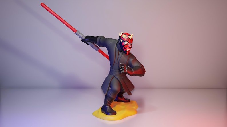May include: A figurine of Darth Maul, a character from Star Wars, is depicted in a dynamic pose. The figure is predominantly black and red, holding a red lightsaber. The base is yellow. The character's face is detailed with red and black markings.