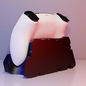 May include: A white gaming controller rests on a black and red stand. The controller has black accents and is positioned on a stand with a jagged, geometric design. The background has a gradient of purple and red.