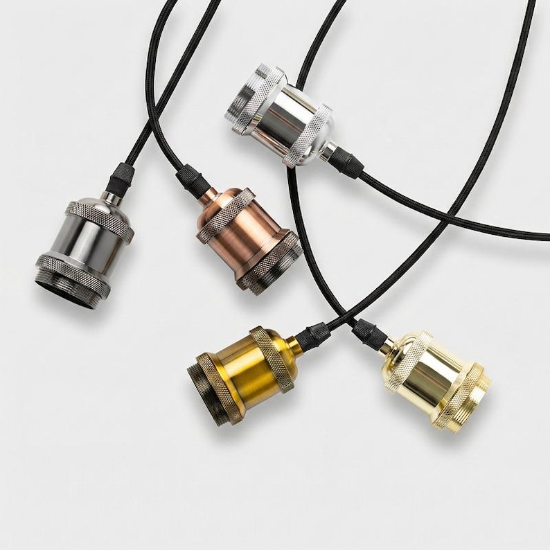 Close-up of pendant light sockets and cords in different finishes