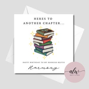 May include: A square greeting card featuring a stack of colourful books with yellow star accents. The text reads: HERES TO ANOTHER CHAPTER... HAPPY BIRTHDAY TO MY BOOKISH BESTIE, followed by the name Harmony in a cursive script font.