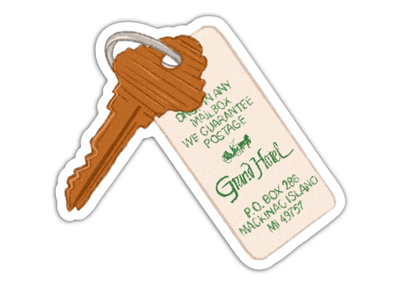 May include: A sticker featuring a vintage-style key and hotel tag. The key is brown with a silver ring. The tag reads "Grand Hotel" with address details and a guarantee of postage.