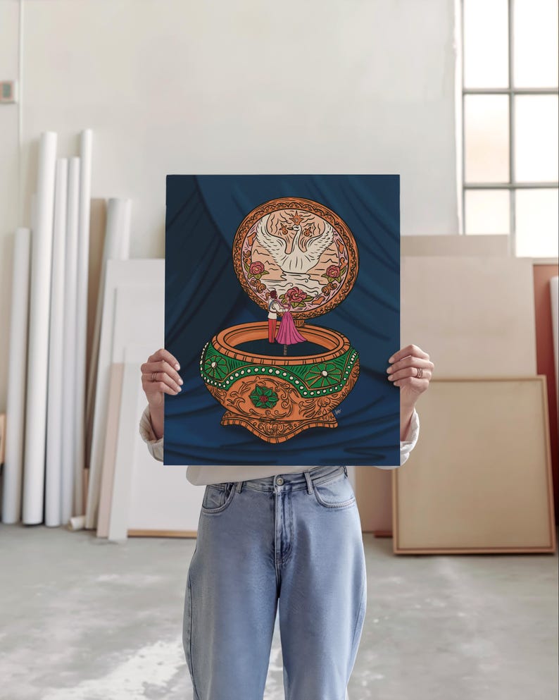 Large art print being held by artist in an art studio featuring Anastasia music box art with elegant floral accents.