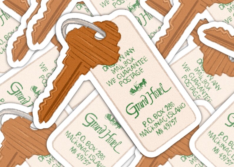 May include: A collection of stickers featuring a vintage-style key and hotel key tag. The tag reads "Grand Hotel" with the address in Mackinac Island, MI. The key and tag are brown with a white border.