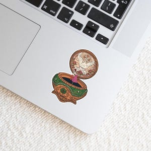 May include: A vintage-style music box with a ballerina inside. The music box is made of gold and green with intricate details. The lid is open and a white dove is flying out.