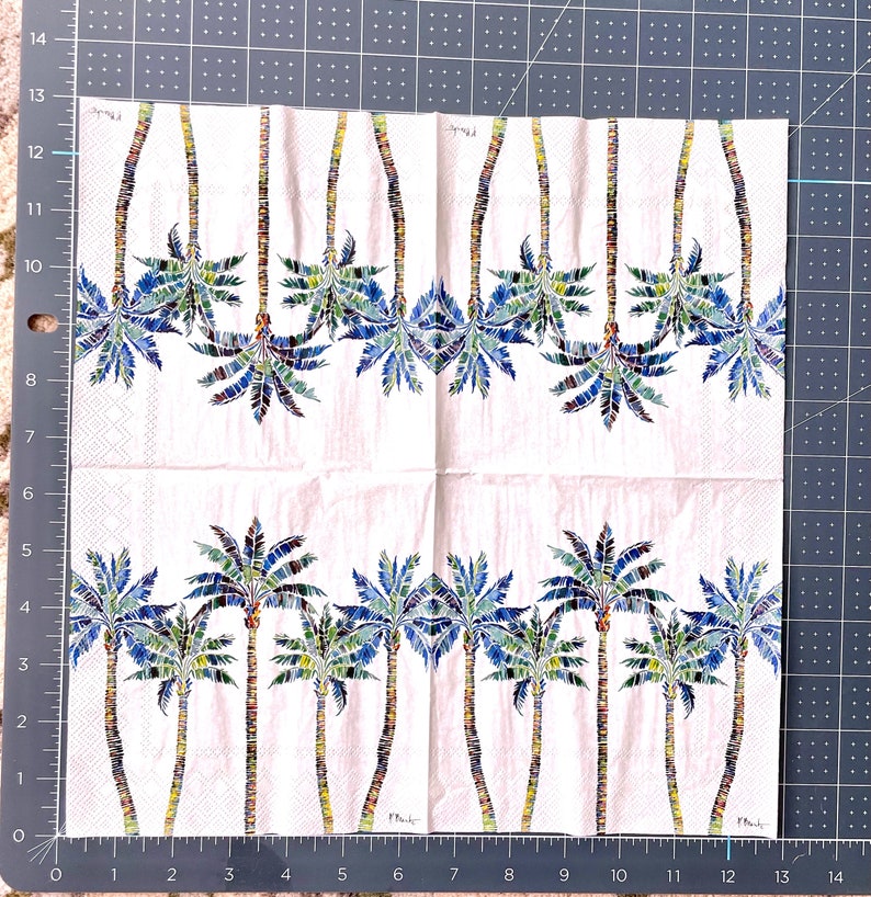 Paper Napkin featuring Blue and green mosaic patten palm leaves with multicolored palm tree trunk