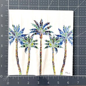 Paper Napkin featuring Blue and green mosaic patten palm leaves with multicolored palm tree trunk