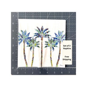 Paper Napkin featuring Blue and green mosaic patten palm leaves with multicolored palm tree trunk