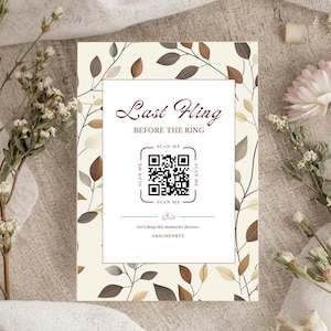 May include: A rectangular invitation card with the text "Last Fling Before The Ring" and a QR code. The card has a cream background with brown and gray leaf and branch designs. The words "Scan Me" are printed on the card.