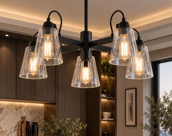 May include: A five-light chandelier featuring a matte black metal frame with straight arms and clear, tapered glass shades. Each light socket holds a visible Edison-style bulb that emits a warm, glowing light, suspended from a central rod.