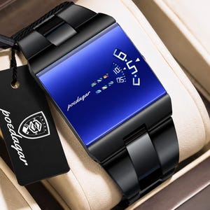 May include: A black metal wristwatch with a rectangular blue face featuring a digital-style display with the text poedagar. The watch includes a black link band and a black rectangular hang tag with the white poedagar logo and text.