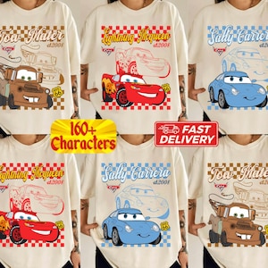 May include: Cream-colored t-shirts featuring cartoon car characters: Tow Mater, Lightning McQueen, and Sally Carrera. Each design includes the character's name, the year 2008, and the Route 66 logo. The shirts have a checkered border.
