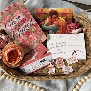 May include: A white ceramic mug with a black handle and the text "But First, Coffee" in a black, handwritten-style font. The mug is on a white surface.