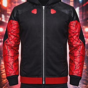 May include: Black zip-up hooded jacket with red accents. The sleeves feature a red web design, and the jacket has a red band at the waist and cuffs. The shoulders have black panels and red geometric shapes.