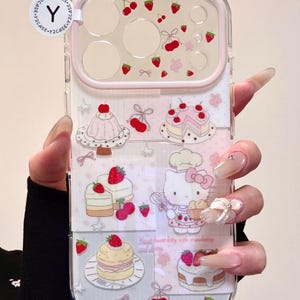 May include: Clear phone case with a pink border, featuring a repeating pattern of strawberries, cherries, and cakes. The design includes a cartoon Hello Kitty character with a chef's hat. The text "Sweet heart kitty with strawberry and cherry" is also visible.