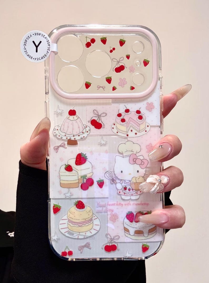 May include: Clear phone case with a pink border, featuring a repeating pattern of strawberries, cherries, and cakes. The design includes a cartoon Hello Kitty character with a chef's hat. The text "Sweet heart kitty with strawberry and cherry" is also visible.
