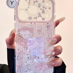 May include: Clear phone case with a pink border and a ballet theme. The case features illustrations of a ballerina cat, bows, ballet shoes, and teddy bears. The text "Sweet Ballet Kitty" is also visible.
