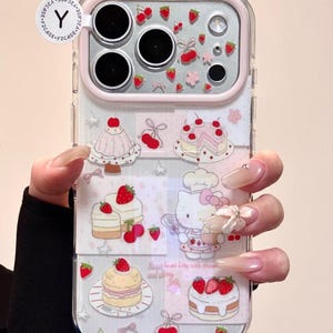 May include: Clear phone case with a pink border and a design featuring cakes, strawberries, and a cartoon character. The case has a clear background with a repeating pattern of desserts and fruit.