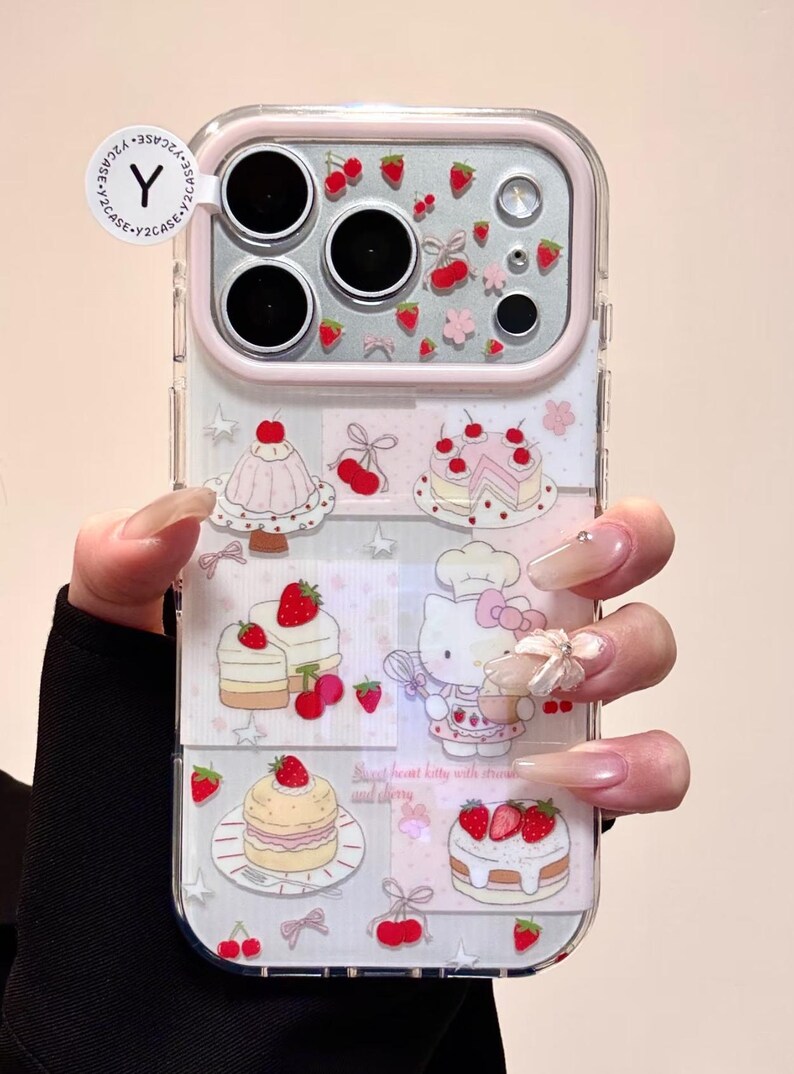 May include: Clear phone case with a pink border and a design featuring cakes, strawberries, and a cartoon character. The case has a clear background with a repeating pattern of desserts and fruit.
