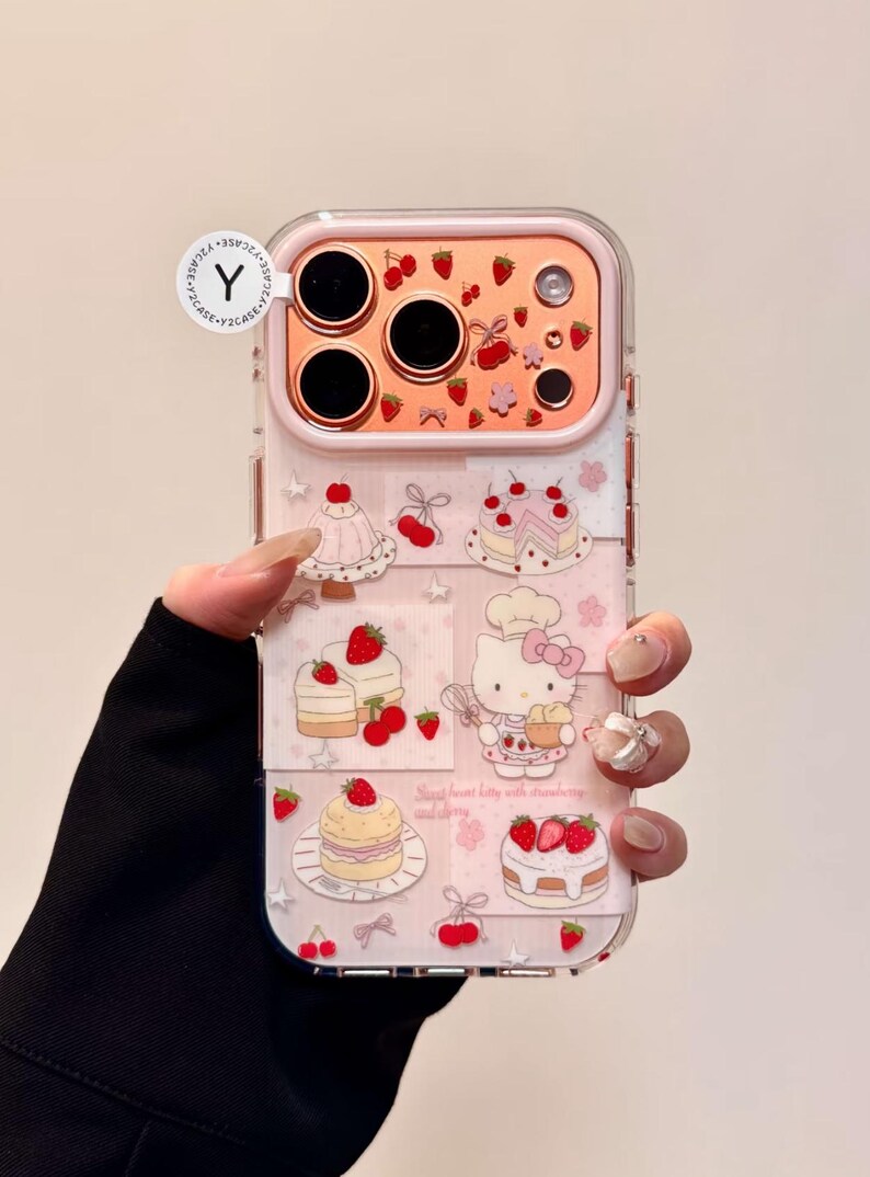 May include: Clear phone case with a pink frame and a design featuring cakes, strawberries, and a cartoon cat. The case has a decorative pattern of pink stars and the text "Sweet heart kitty with strawberry and cherry".