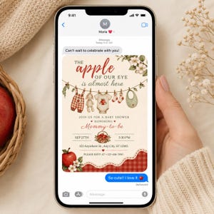 May include: A digital baby shower invitation displayed on a smartphone screen featuring an apple theme. The text reads The apple of our eye is almost here, Join us for a baby shower honoring Mommy-to-be, Sep 27th, 3:30 PM, 123 Anywhere St., Any City, ST 12345, and Please RSVP at +123-456-7890.