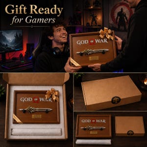 May include: A framed wooden plaque featuring the "God of War" logo and a replica of a sword. The plaque is presented in a gift box with a gold ribbon. The text "Gift Ready for Gamers" is at the top of the image.