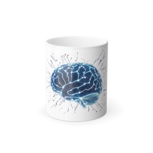 May include: White ceramic coffee mug featuring a blue brain graphic with glowing lines and dots, suggesting neural pathways. The design includes a network of lines and dots, with red and black splatter accents.