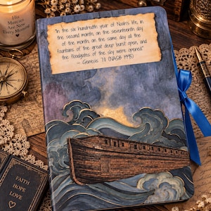 May include: A rectangular journal featuring a dark blue watercolor illustration of a wooden ark on turbulent waves. A parchment-style paper is attached to the cover with the text: In the six hundredth year of Noah's life, in the second month, on the seventeenth day of the month, on the same day all the fountains of the great deep burst open, and the floodgates of the sky were opened. - Genesis 7:11 (NASB 1995). A bright blue ribbon is tied to the side.