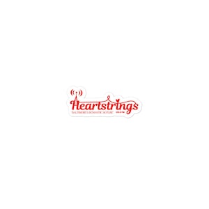 May include: A white sticker with the red text "Heartstrings" in a cursive font. The word "Heartstrings" has a heart symbol in place of the letter "a". Below the text is "Baltimore's Romantic Hotline 103.9 FM".