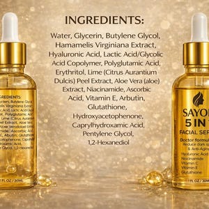 May include: Two gold-colored glass bottles of facial serum with white droppers. The bottles are labeled "SAYON 5 IN 1 FACIAL SERUM" and list ingredients and percentages. The background is a blurred golden color with a white flower.