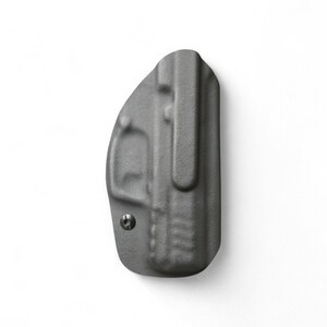 May include: A gray, molded polymer holster with a belt clip. The holster has a textured surface and a small screw. The design is for concealed carry. The holster is shown against a white background.