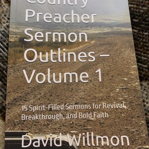 May include: A book cover with the title "Country Preacher Sermon Outlines - Volume 1." The cover features a rural landscape and text that reads "15 Spirit-Filled Sermons for Revival, Breakthrough, and Bold Faith" and the author's name, David Willmon.