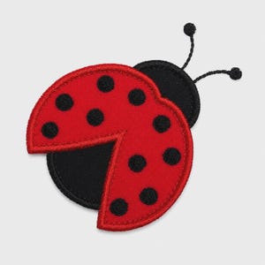 May include: An embroidered ladybug patch featuring a bright red wing section with black circular spots and a solid black head section. Two thin black antennae extend from the top of the head. The entire design is outlined with thick black stitching.