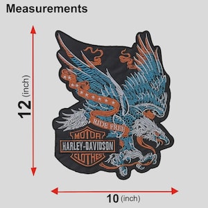 May include: A black embroidered patch featuring a blue and orange eagle with wings spread, a banner reading RIDE FREE, and a Harley-Davidson Motor Clothes logo. The patch measures 12 inches in height and 10 inches in width as indicated by arrows.