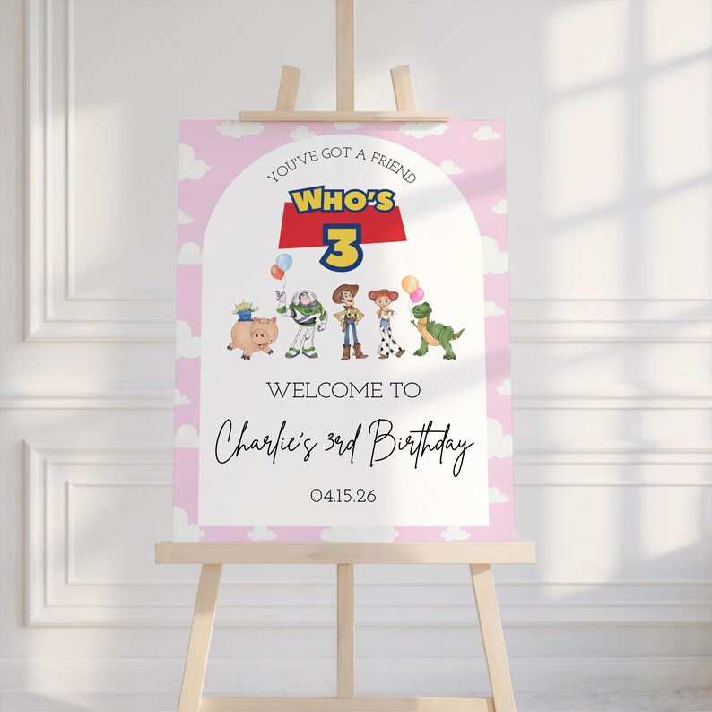 May include: A pink and white birthday welcome sign featuring the phrase "You've Got a Friend Who's 3". The sign includes cartoon character illustrations and the text "Welcome to Charlie's 3rd Birthday" and the date 04.15.26.