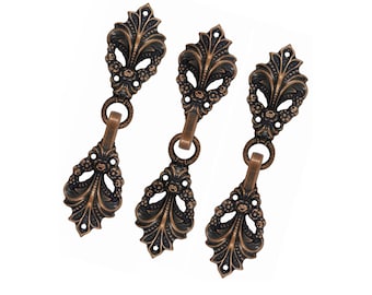 May include: Three matching bronze-toned metal drawer pulls featuring an ornate, elongated leaf-like design with intricate floral detailing. Each pull consists of a fixed top mounting plate and a hinged, dangling handle, both with a dark, aged finish.