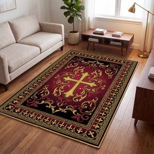 May include: A rectangular area rug featuring a deep red and black gradient background with a central gold cross motif surrounded by ornate gold scrollwork. The border displays a repeating pattern of small gold crosses and fleur-de-lis symbols.