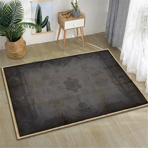May include: A rectangular area rug with a dark gray, vintage map design. The rug has a beige border and is placed on a light-colored wooden floor. The map design features gold-colored lines and decorative elements.