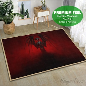 May include: A rectangular rug with a dark red gradient background and a central image of a winged demon. The rug has a beige border and the text "PREMIUM FEEL" and "HomyraDecor" are visible.