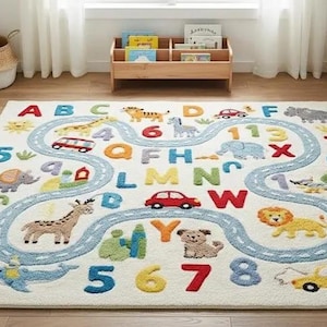 May include: A cream-colored children's rug featuring a road design with colorful letters, numbers, and animal illustrations. The rug includes a blue road, a red car, a giraffe, a lion, and an elephant.