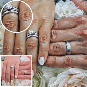 Könnte beinhalten: Ölgemälde von Händen mit Eheringen. Eine Hand trägt einen Diamant-Verlobungsring und einen Ehering. Die andere Hand hat einen schlichten silbernen Ehering. Weiße Blumen sind im Hintergrund.