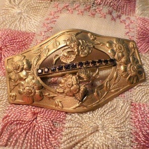 Art Nouveau Brass Brooch: Repousse Floral Design with Purple Stones
