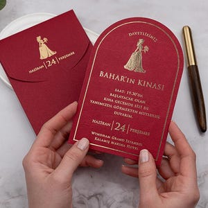 May include: A deep red arched invitation card and matching envelope featuring gold foil text and a silhouette graphic. The invitation displays the text Bahar'in Kinasi, details about the event, and the date Haziran 24 Persembe in gold lettering.