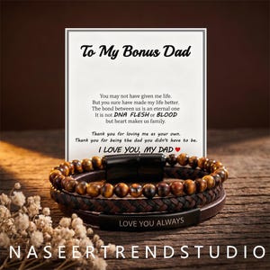 May include: A multi-strand bracelet featuring brown tiger eye beads, a braided dark brown leather cord, and a smooth brown leather strap with a black metal plate engraved with the text LOVE YOU ALWAYS, displayed with a card reading To My Bonus Dad.