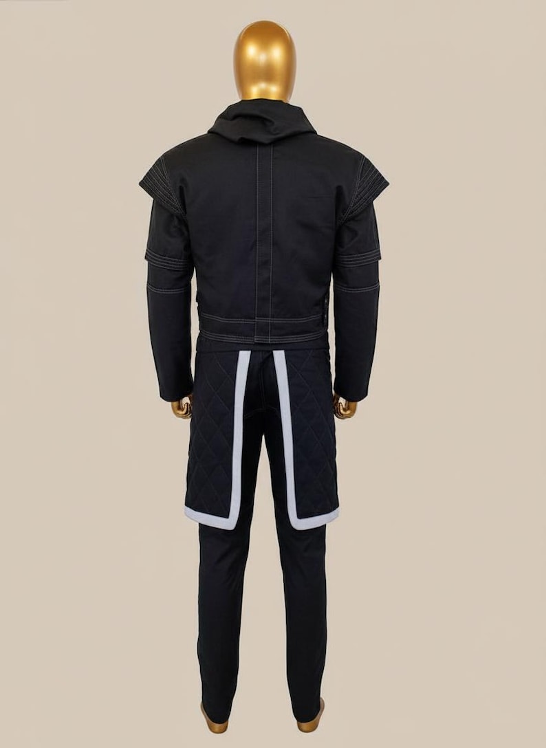 May include: Black jacket and pants set with white stitching and accents. The jacket has a hood and structured shoulders. The pants feature quilted panels with white trim. The outfit is displayed on a mannequin.