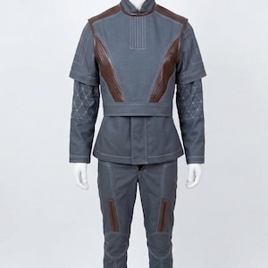 May include: A white ceramic mug with a black handle and the text "But First, Coffee" in a black, bold font. The mug is on a white surface.