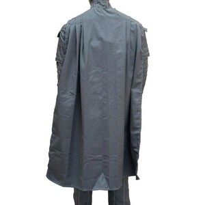 May include: A gray costume with a cape, jacket, and pants. The cape drapes down the back, and the jacket has detailed stitching on the shoulders. The pants have white stitching. The outfit is displayed on a black mannequin.